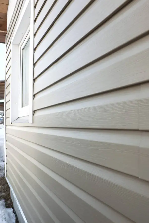 Close up of residential siding materials and window.